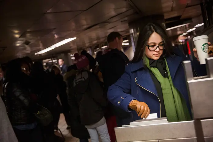 a commuter swipes a MetroCard at Grand Central